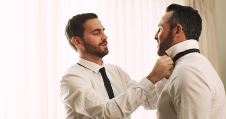 Helping, groom and men with tie, wedding or preparing for ceremony, friends and advice for marriage. Space, talking and people with formal suit in hotel, conversation and assistance with clothes