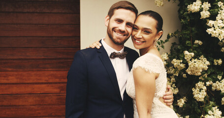 Portrait, bride and groom hug with happy couple for love, care or support for marriage by home. Matrimony, man and woman embrace for wedding, commitment or loyalty to soulmate in relationship outdoor