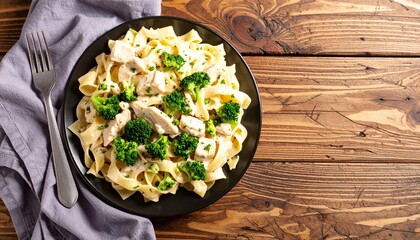 Delicious Plate of Fettuccine Alfredo with Broccoli Shot From Above with Space  for Copy