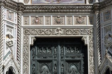 Close-up of ornate main door and marble facade of Florence Cathedral, Tuscany, Italy