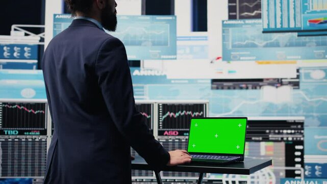 General director with a chroma key display reviewing performance metrics, finance graphs and strategy tools to guide a new investment and decision making. Long term business growth. Camera B.