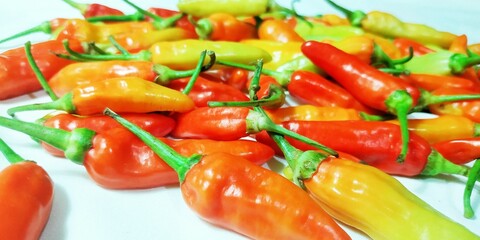 Close-Up Macro Shot of a Heap of Bright Yellow and Orange Chili Peppers, Showcasing Their Glossy Skins and Organic Forms, Ideal for Spicy Food Concepts and Recipe Backgrounds