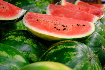 Fresh summer fruit watermelons sold in a market. Healthy vegan nutrition. Sliced ​​watermelons....