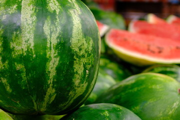 Fresh summer fruit watermelons sold in a market. Healthy vegan nutrition. Sliced ​​watermelons....