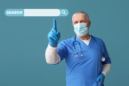 Male doctor pointing at web search engine against blue background