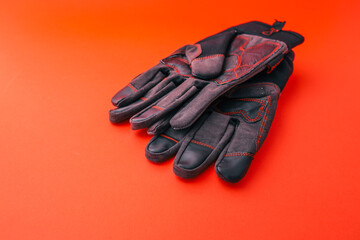 Protective work gloves with reinforced palm and fingers, black and gray color with red stitching,...