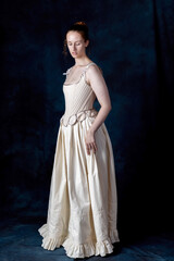 A Renaissance or Georgian woman wearing underwear consisting of boned stays and a corded petticoat