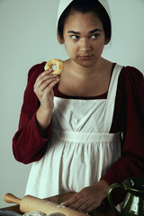 A Regency period working-class woman or servant preparing food