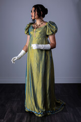 A Regency woman wearing an evening dress with gloves