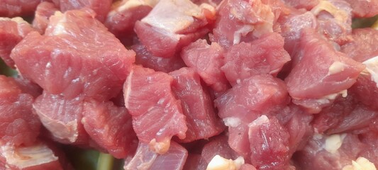 Close-up of fresh raw beef cubes. Perfect for culinary content, butcher shop promotions, recipe illustrations, or meat product advertisements. High-resolution food photo.