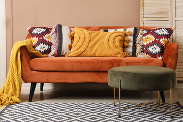 Stylish pillows on sofa in living room