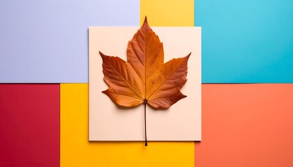 Obraz premium Autumn Maple Leaf on Colorful Geometric Backdrop Fall Season Concept.