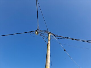 street light pole against a bright blue sky