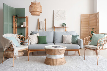 Stylish living room with comfortable armchair, sofa and coffee table