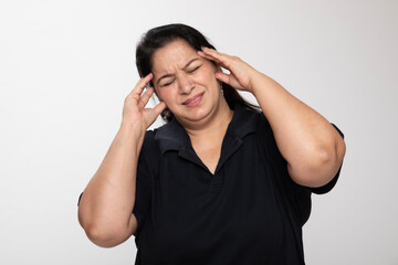 Portrait of an indian matured woman suffering painful headache on grey studio background