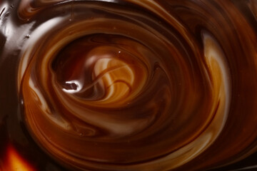 Closeup view of brown twirling coffee as background