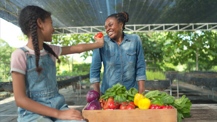 Smiling mom and daughter with a tray of fruit and vegetable