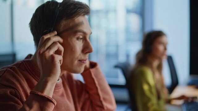 Operator hand taking headphones from computer closeup. Guy work call center