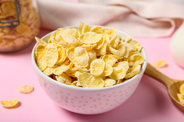 Bowl with delicious cornflakes on pink background, closeup
