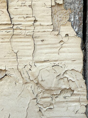 The wall is covered in peeling paint and has a rough texture