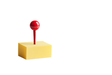 A yellow block with a red pin