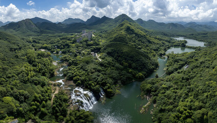 Obraz premium Aerial View of Lush Green Valley with River and Waterfall. A high-resolution aerial view of a winding river cutting through a lush green valley, captured during golden hour