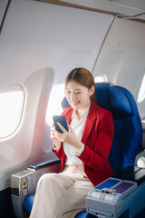 Asian Woman Working on Tablet During  in first class, multitasking with Flight Travel in style, work