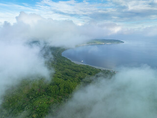 Clouds drift over Binongko Island in Wakatobi National Park, off the coast of Sulawesi. This area is a popular destination for divers and snorkelers due to its high marine biodiversity.