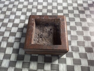 Distressed Wooden Ashtray on Checkered Table