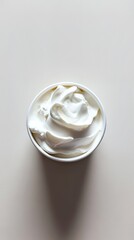 Creamy swirl of whipped topping in a cup, shot from above.