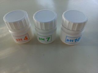 Buffer solutions in bottles. these calibration solutions are commonly found in science laboratories...