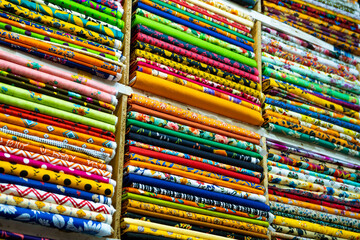 Vibrant Fabric Rolls: A Colorful Textile Market Display