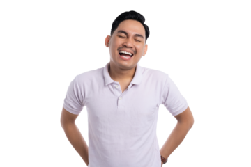 Laughing young Asian man in white polo shirt with hands on hips expressing happiness isolated on transparent background