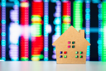 With a house model in the foreground and a data-rich monitor behind it, the image vividly conveys...
