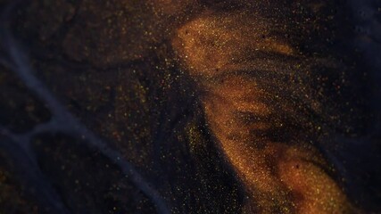 Glitter fluid. Shimmering spill. Golden powder particles paint emerge swirl flowing in black gray gel emulsion art abstract background. - Powered by Adobe