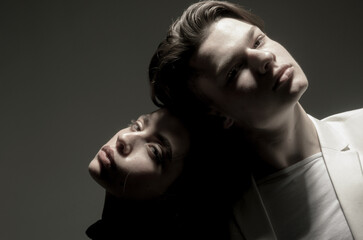 Fashion young couple in studio. Fashion models. Romantic portrait of sensual young couple. Couple in love. Vogue couple embracing. Studio fashion portrait. Catalogue-style look. Fashion shoot.