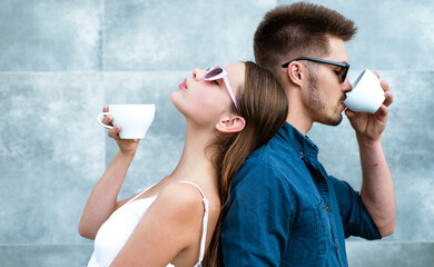 Two friends enjoying a coffee. Romantic portrait of couple drinking coffee. Woman and man enjoying coffee. Cafeteria, aromatic macchiato, mug or cup, cappuccino and espresso. Delicious coffee.