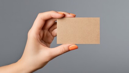 Hand holding a blank kraft business card