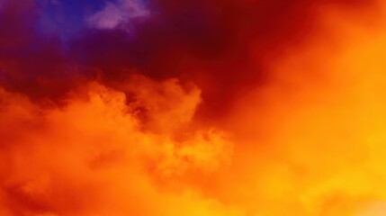 Dramatic and vivid sky scene with a rich palette of deep blue, purple, intense red, bright orange, and yellow hues blending seamlessly. Soft, billowy clouds resembling wisps of cotton candy are suffus