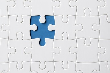 Fototapeta premium Missing Puzzle Piece in White Jigsaw Background Highlighting the Importance of Completion and Problem Solving in Life and Success
