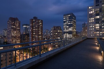 Obraz premium View from rooftop shows city buildings illuminated at dusk with metal railing near