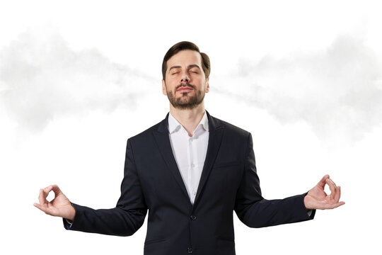 Businessman meditating in suit with steam symbolizing stress relief coming from ears on clean white background. Concept of calm under pressure. 