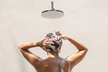 Beautiful woman's hand She was washing her hair and nourishing her scalp. Shampoo and conditioner	
