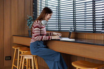 Successful caucasian happy young woman student freelancer using laptop, watching webinars, working...