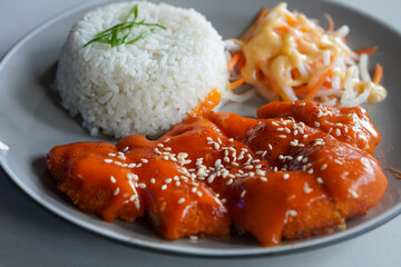 Chicken Katsu with Mentai, Indonesia, captured on June 16, 2025. Crispy breaded chicken cutlet topped with creamy mentaiko sauce, combining Japanese and local flavors in a savory fusion dish.