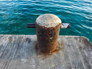 The bollards are rusty. A mooring pole is a tool used in ports to tether ship ropes or a tool or...