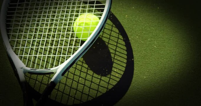 Sunlit lens zooming out showing tennis racket and ball resting on green surface highlighting gear
