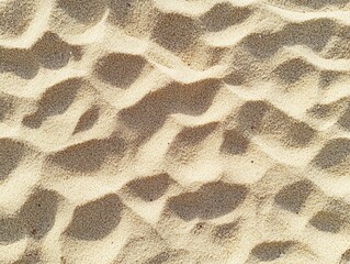 Close-Up View of Soft Sand Texture with Natural Patterns and Shadows