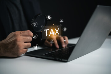 Close-up of Hand Holding Magnifying Glass Over Laptop with Tax Icons and Symbols, Concept of Tax Assessment, Financial Review and Digital Research