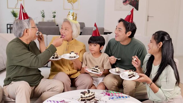 Three-Generation Family Celebrates with Cake and Joy